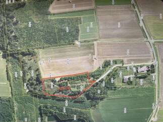 Discover this expansive parcel of land, highlighted by a red boundary, offering a unique opportunity for development or agricultural use.
