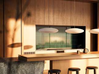 Experience modern living in this stunning kitchen featuring a sleek wooden island with a stone base, perfect for casual dining or entertaining.