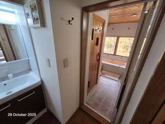 Discover this charming property featuring a well-appointed vanity and sink area, perfect for morning routines.