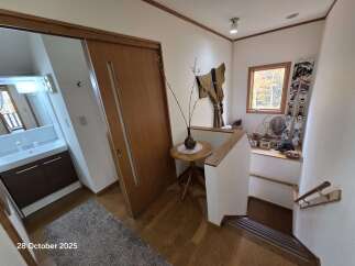 Step into this inviting entryway featuring a sleek sliding door and a modern vanity area.