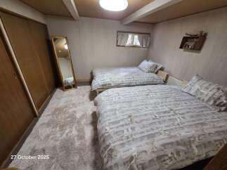 This charming bedroom features two comfortable twin beds, perfect for accommodating guests or family.