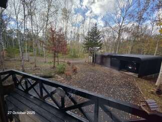Experience the serene beauty of autumn from this property, nestled amidst a picturesque forest.