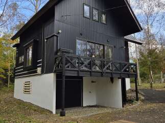 Discover this modern black A-frame home nestled in a serene natural setting, perfect for a tranquil getaway.