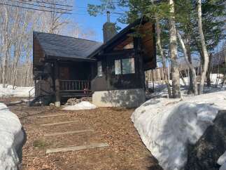 Escape to this charming rustic cabin nestled in a serene wooded setting, perfect for a tranquil getaway.