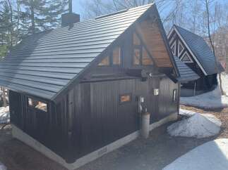 Discover this charming A-frame cabin nestled in a serene, wooded setting.