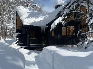 Experience the ultimate winter wonderland with this charming cabin nestled in a snow-covered forest.