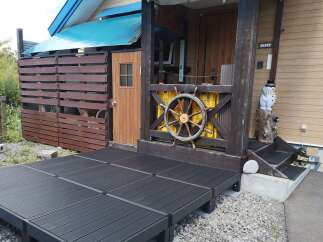 Discover this charming property featuring a spacious dark wood deck, perfect for outdoor relaxation and entertaining.