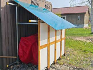 Discover this charming property featuring a unique outdoor storage solution with a vibrant blue roof, perfect for protecting your belongings.