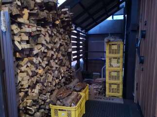 Discover a unique property featuring an abundance of neatly stacked firewood, perfect for cozy evenings.