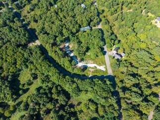 Discover this secluded property nestled within a lush, green forest, offering a tranquil escape.