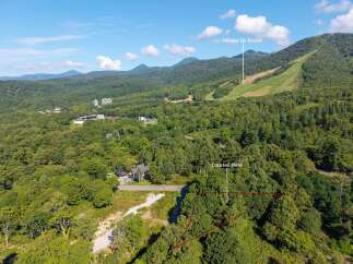 Discover this prime property nestled amidst lush greenery, offering a serene escape with stunning mountain views.
