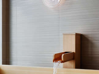Experience ultimate relaxation in this luxurious bathroom featuring a traditional wooden soaking tub.