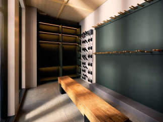 Discover this modern walk-in closet featuring sleek dark shelving with integrated lighting, perfect for organizing your wardrobe.