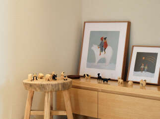 This charming corner features a rustic wooden stool adorned with a collection of adorable animal figurines, creating a whimsical display.