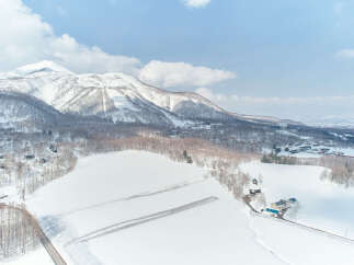 Experience the serene beauty of a winter wonderland with this stunning aerial view of a snow-covered landscape.