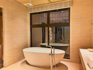 Experience ultimate relaxation in this luxurious bathroom, featuring a freestanding soaking tub perfect for unwinding.