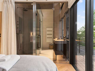 Experience modern luxury in this stunning bathroom featuring a spacious glass-enclosed shower and a sleek vanity.