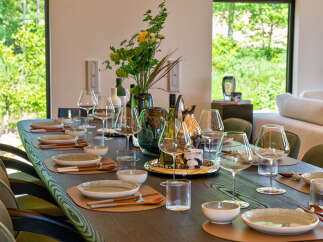 Experience elegant dining in this stunning home, featuring a beautifully set table perfect for hosting.