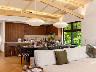Experience modern living in this open-concept home featuring a gourmet kitchen with rich wood cabinetry and a spacious dining area perfect for entertaining.