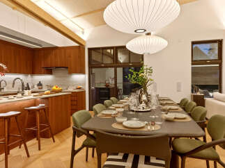 Experience modern living in this stunning home featuring a gourmet kitchen with rich wood cabinetry and a spacious dining area perfect for entertaining.