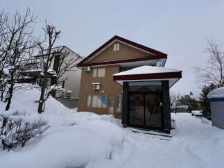 Experience the charm of this snow-covered residence, perfect for a winter getaway.