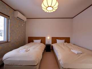 This cozy hotel room features two comfortable twin beds, perfect for solo travelers or friends.