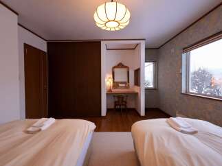 Experience comfort and style in this inviting bedroom, featuring two plush beds perfect for a restful night's sleep.