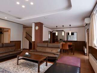 Experience comfort and style in this spacious living area, featuring plush leather sofas perfect for relaxation.