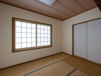 Experience traditional Japanese living in this serene room featuring tatami flooring and shoji screens.