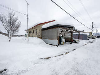 Embrace the winter wonderland with this property featuring a covered carport, perfect for protecting vehicles from heavy snowfall.