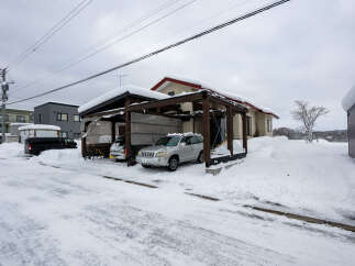 Embrace the winter wonderland with this charming property, perfectly situated in a snow-covered landscape.