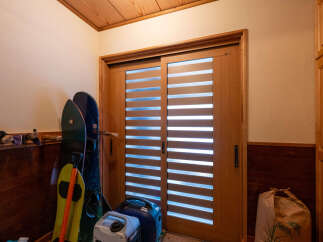 Discover a home with a stylish sliding door featuring horizontal slats, perfect for adding a modern touch to your entryway.