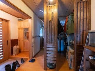 Discover a charming entryway featuring a sliding wooden door and ample storage with built-in cabinets.