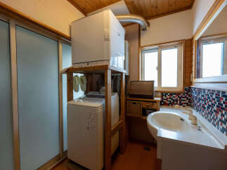 Discover this charming bathroom featuring a stacked washer and dryer for ultimate space efficiency.