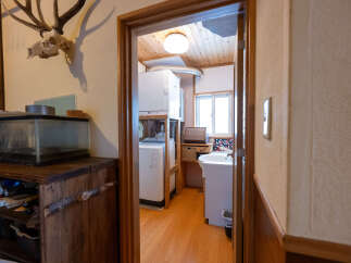 Discover a unique living space featuring a rustic wooden cabinet with a built-in aquarium, perfect for adding a touch of nature to your home.