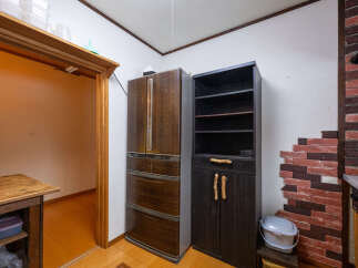 Discover a charming kitchen space featuring a vintage-style refrigerator and a dark wood cabinet with unique twig handles.