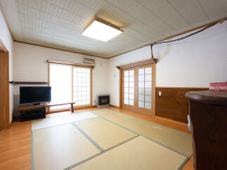 Experience traditional Japanese living in this spacious room featuring tatami flooring and shoji screen doors.