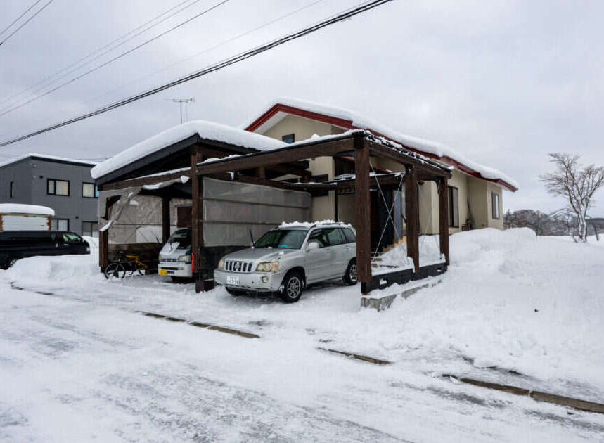 Experience the charm of winter living in this picturesque property, featuring a covered carport perfect for protecting your vehicles from the snow.