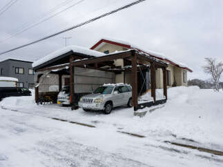Experience the charm of winter living in this picturesque property, featuring a covered carport perfect for protecting your vehicles from the snow.