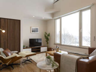 Experience modern living in this stylish apartment, featuring a spacious living area with a large window offering scenic views.