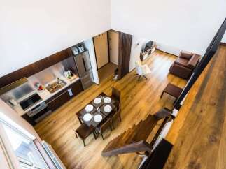 Discover modern living in this stylish loft apartment, featuring a sleek, integrated kitchen with stainless steel appliances and ample counter space.
