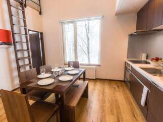 Experience cozy living in this charming dining and kitchen area, featuring a warm wooden dining set with seating for four and a convenient bench.