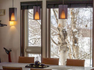 Experience cozy dining with a view in this inviting space, featuring comfortable seating and a stylish tea set.