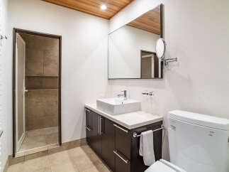 Experience modern comfort in this well-appointed bathroom, featuring a sleek vanity with a vessel sink and a large mirror.