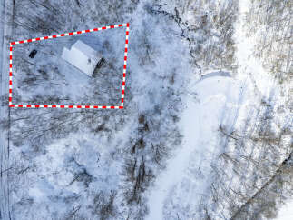 Discover this charming property nestled in a serene, snow-covered landscape.