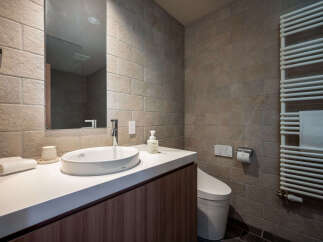 Experience modern comfort in this well-appointed bathroom, featuring a sleek vanity with an integrated sink and a stylish faucet.