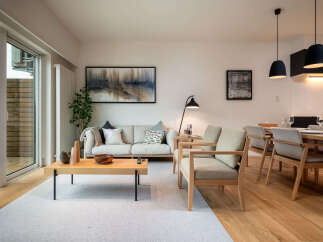 Experience modern living in this beautifully appointed apartment, featuring a spacious open-plan living and dining area perfect for entertaining.