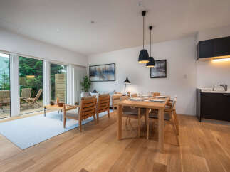 Experience modern living in this beautifully appointed dining and living area, featuring a sleek dining set perfect for intimate meals and a comfortable lounge space for relaxation.