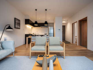 Experience modern living in this beautifully appointed apartment, featuring a sleek open-plan kitchen and a comfortable living area.