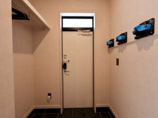 Discover modern living with this stylish entryway featuring a sleek white door and a convenient built-in closet space.